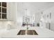 Bright kitchen featuring quartz countertops, a modern faucet, and an open view to the living area at 2700 E Cherry Creek South Dr # 216, Denver, CO 80209