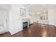 Open-concept living room with a fireplace, wood floors, and a view into the kitchen at 2700 E Cherry Creek South Dr # 216, Denver, CO 80209