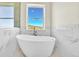 Luxurious bathroom with freestanding bathtub and mountain views at 5585 Country Club Dr, Larkspur, CO 80118