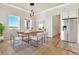 Bright dining room with wood table and modern chairs at 5585 Country Club Dr, Larkspur, CO 80118