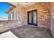 Front entrance with stone accents and double doors at 5585 Country Club Dr, Larkspur, CO 80118