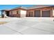 Three-car garage and stone exterior, expansive driveway at 5585 Country Club Dr, Larkspur, CO 80118