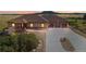 House exterior at dusk with a three car garage at 5585 Country Club Dr, Larkspur, CO 80118