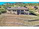 Back of house with hilltop views and stone retaining walls at 5585 Country Club Dr, Larkspur, CO 80118