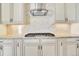 Modern kitchen features gas cooktop and marble backsplash at 5585 Country Club Dr, Larkspur, CO 80118