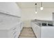 Modern kitchen with white cabinets and marble backsplash at 5585 Country Club Dr, Larkspur, CO 80118