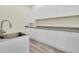 Modern laundry room with stainless steel sink and cabinets at 5585 Country Club Dr, Larkspur, CO 80118