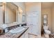 Bright bathroom features a vanity with granite countertop, framed mirror, modern lighting, and tiled floors at 4856 Cheyenne Dr, Larkspur, CO 80118