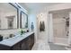 Bright bathroom featuring a double vanity with modern fixtures and a shower-tub combination at 4856 Cheyenne Dr, Larkspur, CO 80118