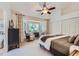 This bedroom has a bay window nook, a ceiling fan, and built-in closet space to create a cozy and functional retreat at 4856 Cheyenne Dr, Larkspur, CO 80118