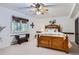 The bedroom features a decorative wood-framed bed, plenty of natural light, and decorative wall art at 4856 Cheyenne Dr, Larkspur, CO 80118