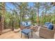 Spacious deck offering ample seating and scenic views of the surrounding trees at 4856 Cheyenne Dr, Larkspur, CO 80118