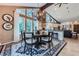 Open-concept kitchen and dining area with modern light fixtures and vaulted ceilings at 4856 Cheyenne Dr, Larkspur, CO 80118