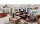 An expansive living room featuring neutral decor, a comfortable seating area, and a view into the bar and game room at 4856 Cheyenne Dr, Larkspur, CO 80118