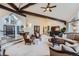 Spacious living room featuring high ceilings, exposed beams, and designer furnishings at 4856 Cheyenne Dr, Larkspur, CO 80118