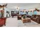 An expansive living room with neutral decor, comfortable seating, and a view of the bar, game room, and exercise room at 4856 Cheyenne Dr, Larkspur, CO 80118