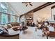 Inviting living room with stone fireplace, vaulted ceilings, and a view of the dining room at 4856 Cheyenne Dr, Larkspur, CO 80118