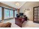 This home office features a large window, modern lighting, and a spacious desk area for remote work or study at 4856 Cheyenne Dr, Larkspur, CO 80118