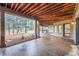 Expansive covered patio perfect for entertaining, with views of the surrounding wooded landscape at 4856 Cheyenne Dr, Larkspur, CO 80118