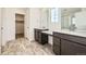 Bathroom featuring dual vanities with white countertops, modern fixtures, and tile floors at 4858 Astor Pl, Brighton, CO 80601