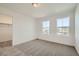 Bright bedroom with carpet, natural light from dual windows, and closet access at 4858 Astor Pl, Brighton, CO 80601