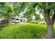 Beautiful, expansive backyard with a well-manicured lawn, mature trees, and spacious patio at 9846 Spring Hill Ln, Highlands Ranch, CO 80129