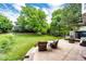 Enjoy this private, well-maintained backyard with lush green lawn and mature trees at 9846 Spring Hill Ln, Highlands Ranch, CO 80129