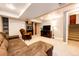 Finished basement offers space for recreation, with carpeted floors and comfortable seating, stairs and storage at 9846 Spring Hill Ln, Highlands Ranch, CO 80129