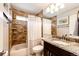 This bathroom features tiled walls and flooring, vanity with granite countertop, sink and toilet at 9846 Spring Hill Ln, Highlands Ranch, CO 80129
