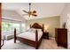 Vaulted ceiling main bedroom with large window and wooden furniture at 9846 Spring Hill Ln, Highlands Ranch, CO 80129