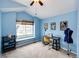 Bedroom with blue walls and a high ceiling, offers a ceiling fan and window seat. Has sewing table and accessories at 9846 Spring Hill Ln, Highlands Ranch, CO 80129