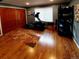 Bright exercise room with wood floors, complete with elliptical machine, yoga accessories and built in storage at 9846 Spring Hill Ln, Highlands Ranch, CO 80129