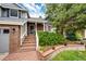 Inviting front porch with brickwork, lush greenery, and an American flag for a welcoming touch at 9846 Spring Hill Ln, Highlands Ranch, CO 80129