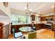 Eat-in kitchen with a large window, stainless steel appliances, and a glass table at 9846 Spring Hill Ln, Highlands Ranch, CO 80129