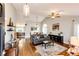 Spacious living room featuring hardwood floors, vaulted ceilings, and an open layout at 9846 Spring Hill Ln, Highlands Ranch, CO 80129
