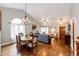 Open-concept living and dining area with hardwood floors, large windows, and stylish furniture at 9846 Spring Hill Ln, Highlands Ranch, CO 80129
