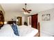 The main bedroom has a vaulted ceiling, carpeted floor, ceiling fan, and access to a private ensuite bathroom at 9846 Spring Hill Ln, Highlands Ranch, CO 80129