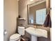 Elegant powder room with pedestal sink and framed mirror at 7395 Slate Ct, Castle Rock, CO 80108