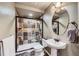 Basement bathroom with shower, toilet, and pedestal sink at 7395 Slate Ct, Castle Rock, CO 80108