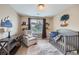 Charming bedroom with crib and accent chair at 7395 Slate Ct, Castle Rock, CO 80108