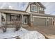 Two-story house with gray siding, a three-car garage, and a covered porch at 7395 Slate Ct, Castle Rock, CO 80108