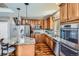 Modern kitchen with granite countertops, stainless steel appliances, and hardwood floors at 7395 Slate Ct, Castle Rock, CO 80108