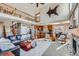 Two-story living room with a fireplace, hardwood floors, and a lofted area at 7395 Slate Ct, Castle Rock, CO 80108