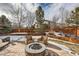 Stone patio with fire pit and seating area in winter at 7395 Slate Ct, Castle Rock, CO 80108