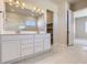 Bathroom with a double vanity, lots of lighting and a view into the bedroom at 14136 Bunny Hop Ln, Parker, CO 80134