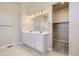 Bathroom showcasing double sinks, ample counter space, and a large mirror at 14136 Bunny Hop Ln, Parker, CO 80134