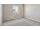 Bedroom with neutral walls, plush carpet, and a bright window at 14136 Bunny Hop Ln, Parker, CO 80134