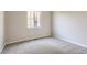 Bedroom with neutral walls, plush carpet, and a window providing natural light at 14136 Bunny Hop Ln, Parker, CO 80134