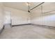 Spacious garage ready for customization, showcasing a functional garage door opener and ample room for vehicles and storage at 14136 Bunny Hop Ln, Parker, CO 80134