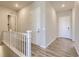 Bright hallway featuring wood-look floors and white doors with modern hardware at 14136 Bunny Hop Ln, Parker, CO 80134